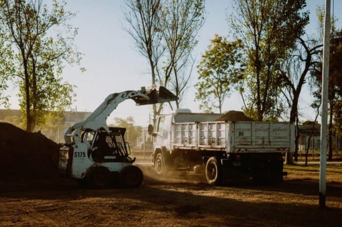 Skid steer loader in use.