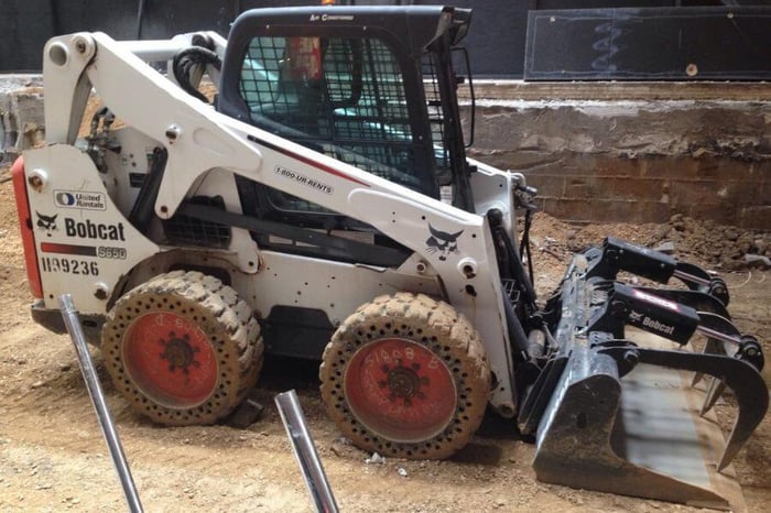Parked skid steer loader.