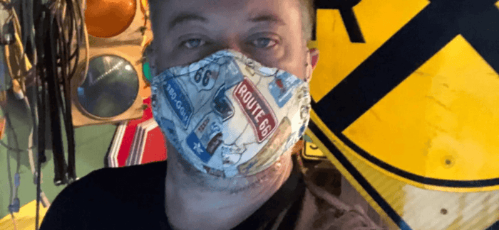 Reselling tips - Man standing in front of resold traffic lights.