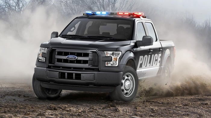 Ford truck used by police forces, drifting in dirt.