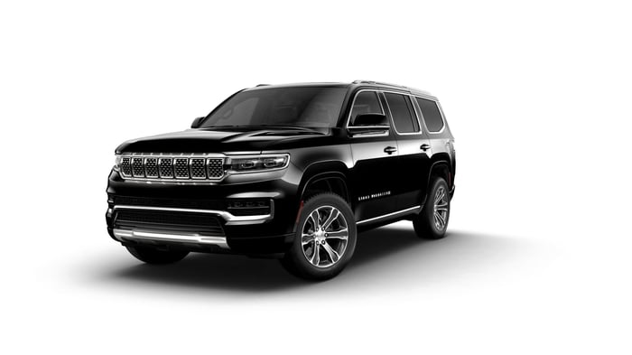 Best SUVs for towing, Black Jeep Grand Wagoneer, with a luxurious interior offering third row seating, towing a maximum weight of 9,750 lbs.