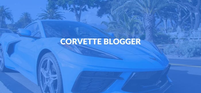 Best Automotive Sites - image of a cyan corvette driving down a street.