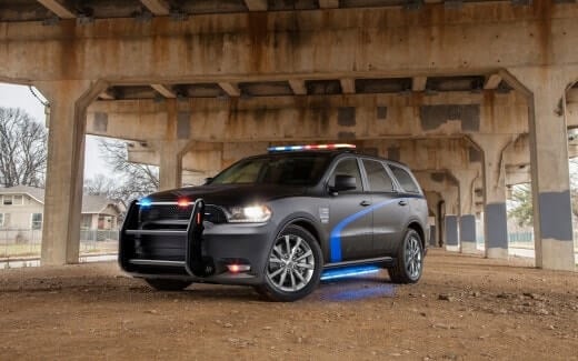 2019 Dodge Durango Pursuit police vehicle in black, parked under a bridge.