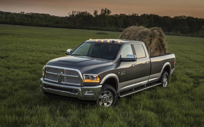 Grey Ram 2500 truck crew cab with digital rearview mirror, hauling a bale.
