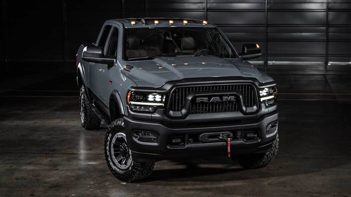 Grey Ram truck with different engine options, impressive off road power, max payload capacity of 4000 pounds, and ability to tow large cargo weight and a flatbed trailer.