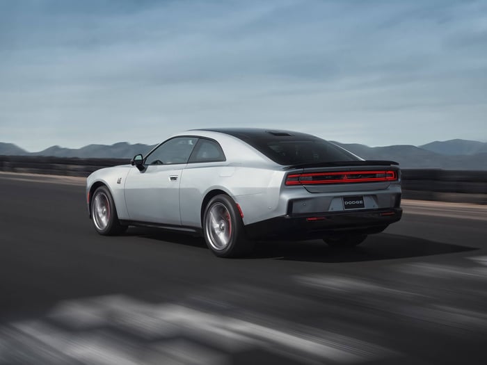 2024 Dodge Charger Daytona in silver color driving on the road.