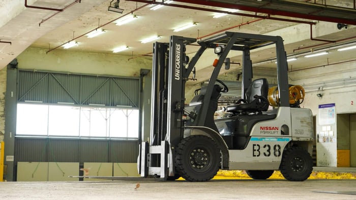 White rough terrain forklift, a good example of material handling equipment, construction equipment, and heavy equipment.