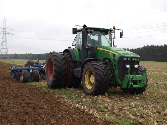 John Deere 8330 row-crop tractor, performing agricultural tasks.
