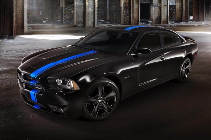 2011 black modern Charger under a bridge.