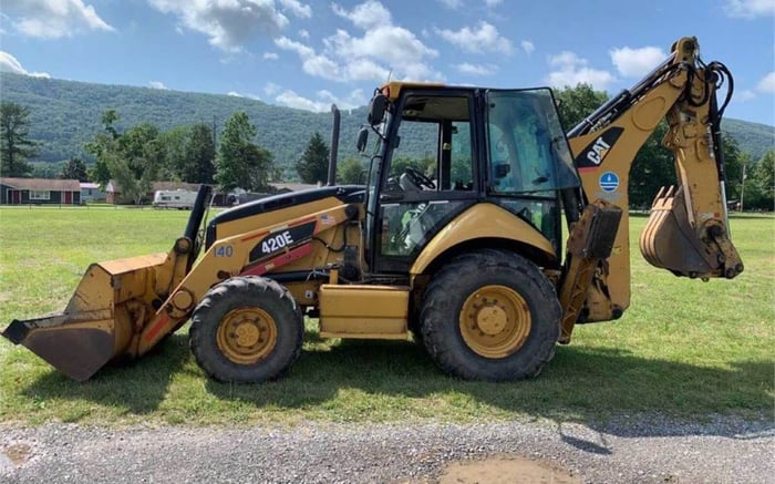 Backhoe loader parked in a field.