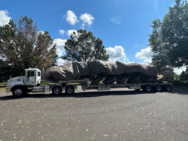 A Lingo fleet truck transporting landscaping materials to a worksite.