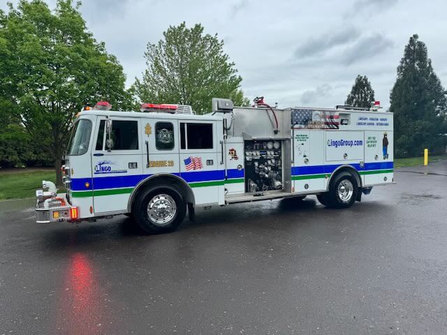 The Lingo Group in the community with a fire truck.