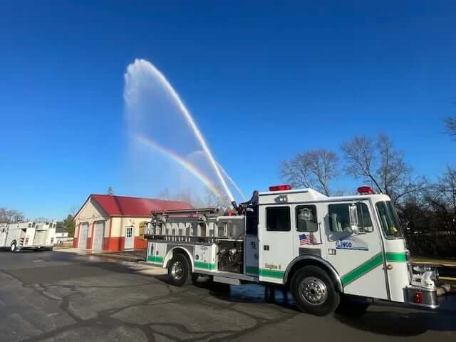 The Lingo Group in the community with a fire truck.