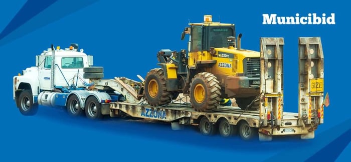 transporting heavy equipment guide, image of tractor being transported