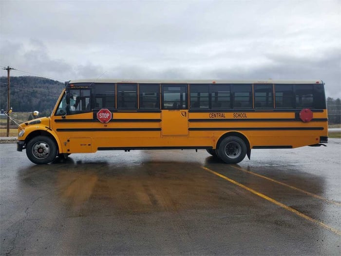 An image of a school bus sitting in a parking lot, facing left. The bus says 'Central School" on the side.