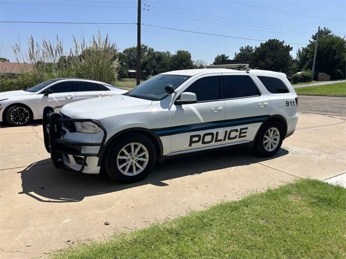 An image of a 2020 Dodge Durango, which was once a police car and is still labeled as such.