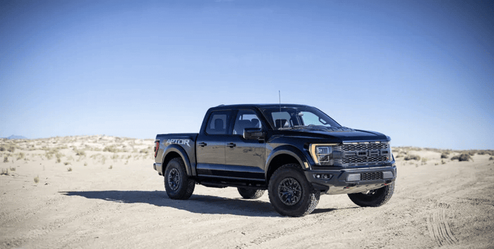 Black Ford F 150 Raptor, available in three cab styles, with rearview mirrors and enhancements to increase the truck's performance.