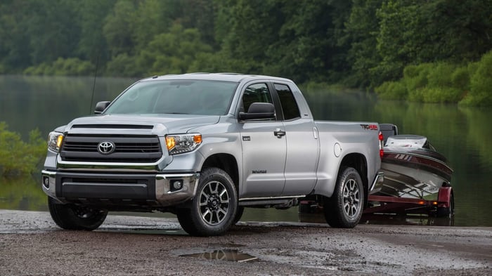 Silver Toyota Tundra with diesel engine demonstrating towing power by towing a heavy load out of a lake.