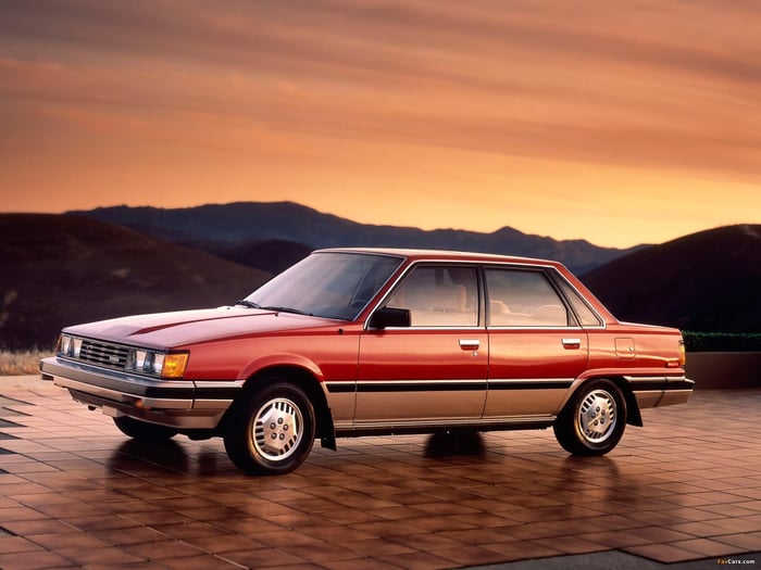 1982 used Toyota Camry car parked at sunset with mountains in the background.