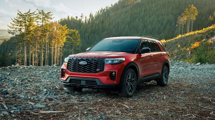Red Ford car parked in the mountains, without a human in sight.