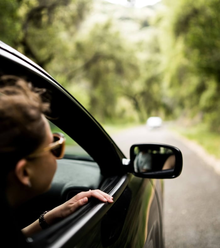 Driving a car on the interstate highway.
