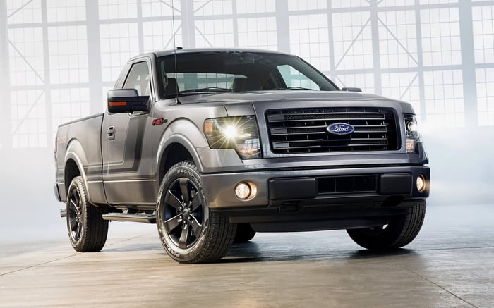 Silver 2013 model year Ford F-150 single cab in a large building with natural light coming in the windows.