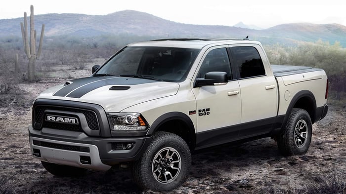 White Ram 1500, with diesel engine option, crew cab, and infotainment system, parked in the desert.