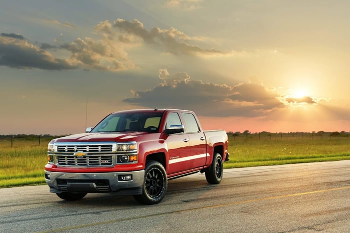 Red Chevy truck with with 12.2–12.9 liters per 100 kilometers fuel economy, crew cab, high interior quality, and child safety seats.