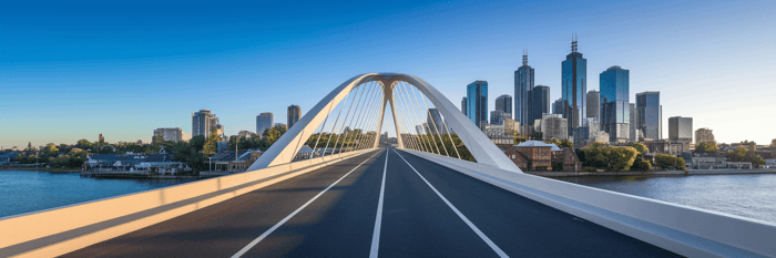 Modern bridge connecting two different landscapes.