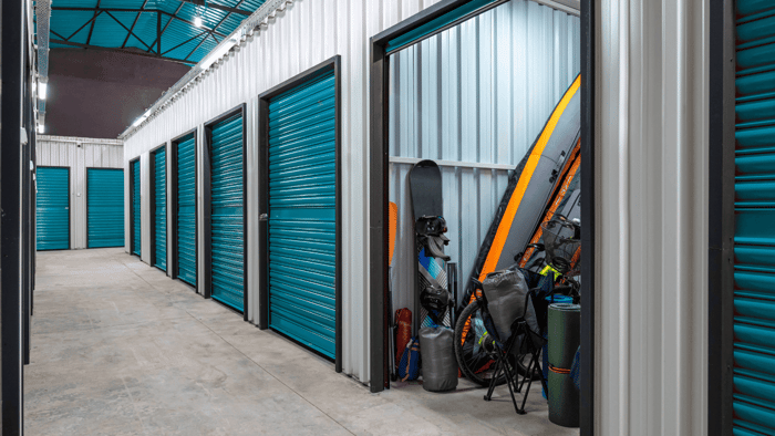 Bicycles, recreational gear, and seasonal household items organized inside a storage unit