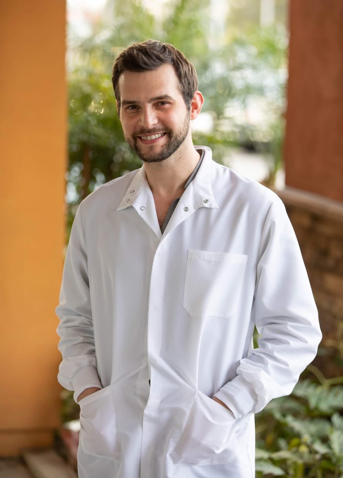 A dentist wearing a white robe