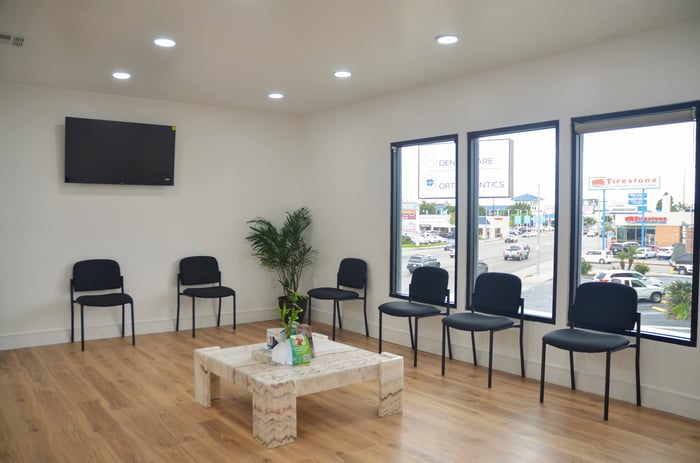 A photo of a patient's lobby with black chairs