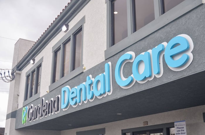 Exterior of Gardena Dental Care building with modern signage and second-story windows.