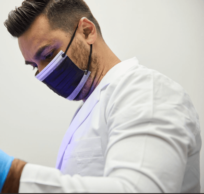 A person wearing a face mask and a gloves