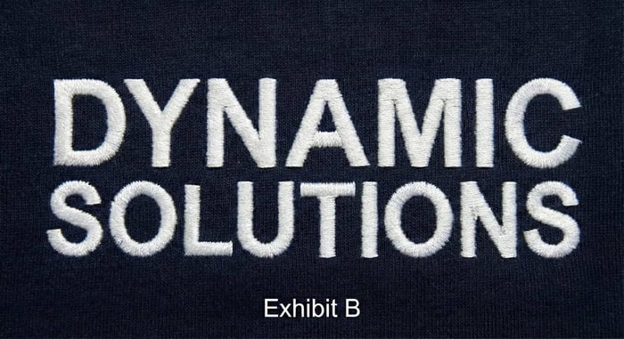 Custom Branded Uniforms Close up of high density logo embroidery on premium corporate apparel.