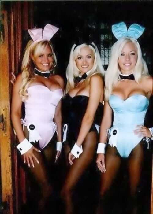 three women in bunny costumes posing for a photo
