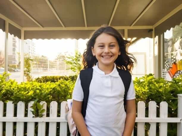 Portrait of a young student girl smiling outside the school Portrait of a young student girl smiling outside the school girl-8-years-old stock pictures, royalty-free photos & images Portrait of a young student girl smiling outside the school Portrait of a young student girl smiling outside the school girl-8-years-old stock pictures, royalty-free photos & images
