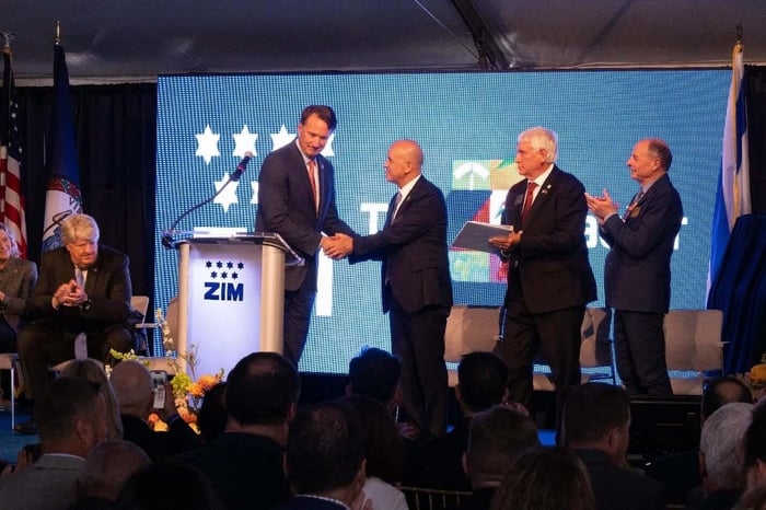 A group of men shaking hands Description automatically generated