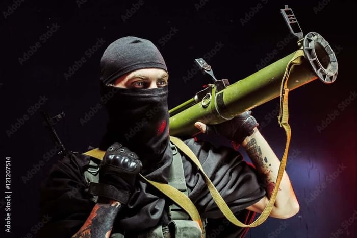 Man aiming through bazooka gun Stock Photo | Adobe Stock