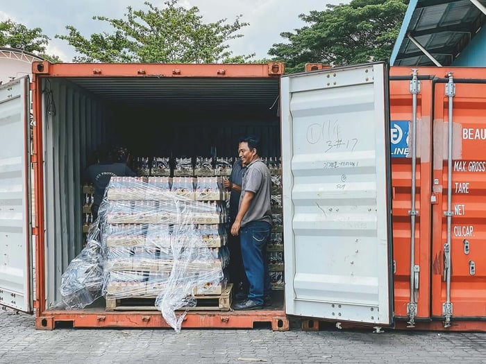Man Standing in Container with Bottles · Free Stock Photo