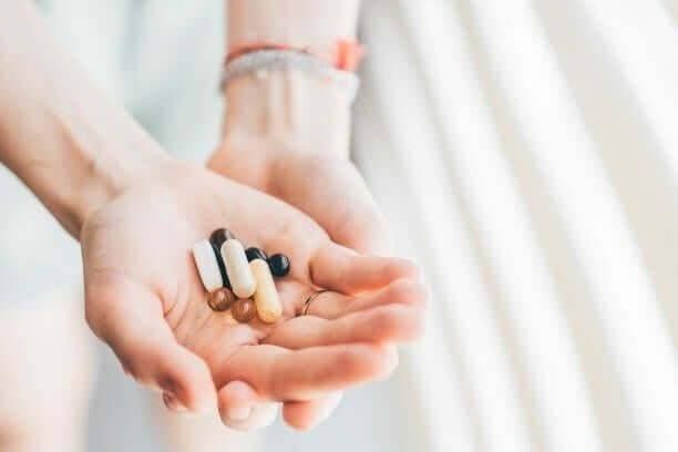 woman taking vitamins and supplements. - vitamins and minerals stock pictures, royalty-free photos & images woman taking vitamins and supplements. - vitamins and minerals stock pictures, royalty-free photos & images
