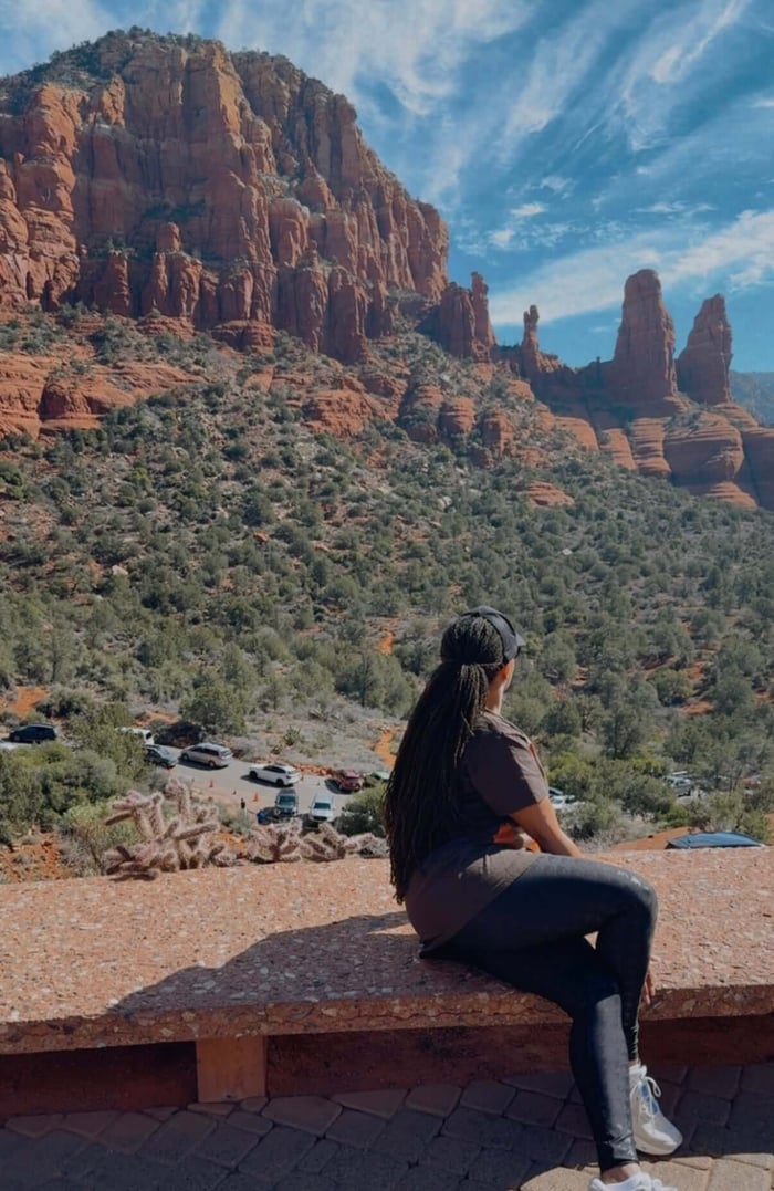 Woman with locs enjoying a quiet moment in Sedona while reflecting on grounding and nature.
