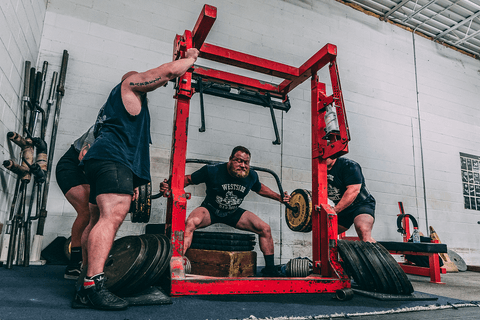 Bully cambered bar box squat at Westside Barbell