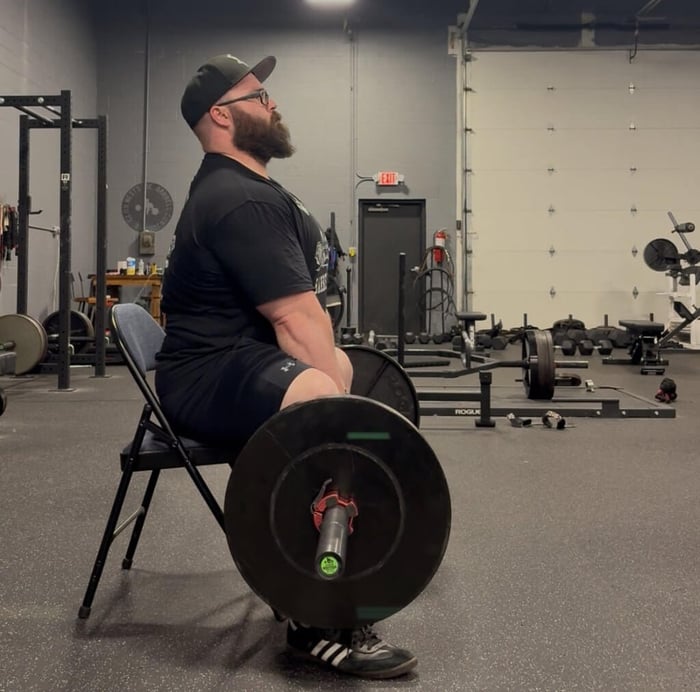 Athlete performing seated deadlift.