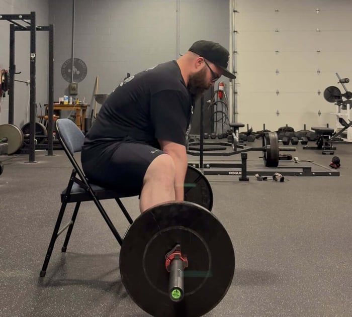 Athlete performing seated deadlift.