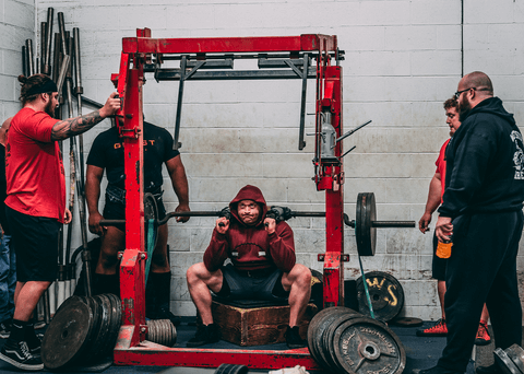 Low box squat using safety squat bar at Westside Barbell