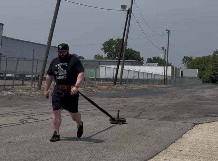 Athlete performing forward sled pull.