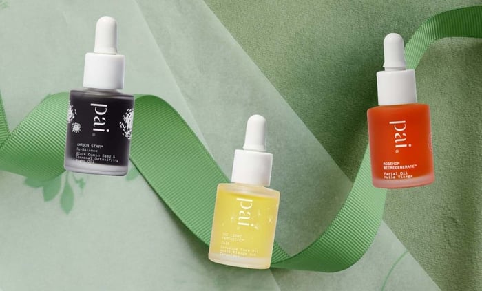 Three Pai face oils arranged on green ribbon - Carbon Star detoxifying oil, Light Work vitamin C serum, and Rosehip BioRegenerate face oil