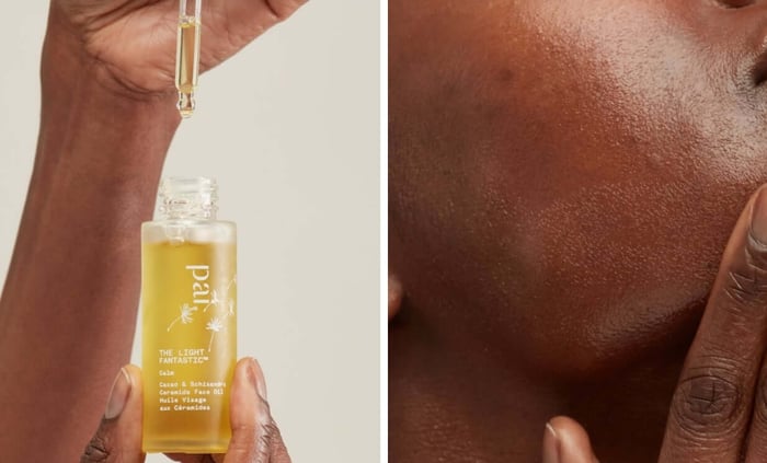 Hand applying The Light Fantastic Ceramide Face Oil with dropper, showing golden oil formula on deeper skin tone