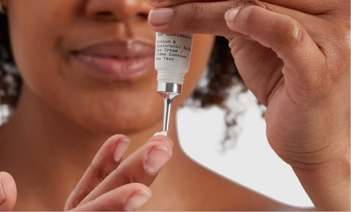 Woman applying Age Confidence Hyaluronic Acid Eye Cream, unretouched skin showing natural texture